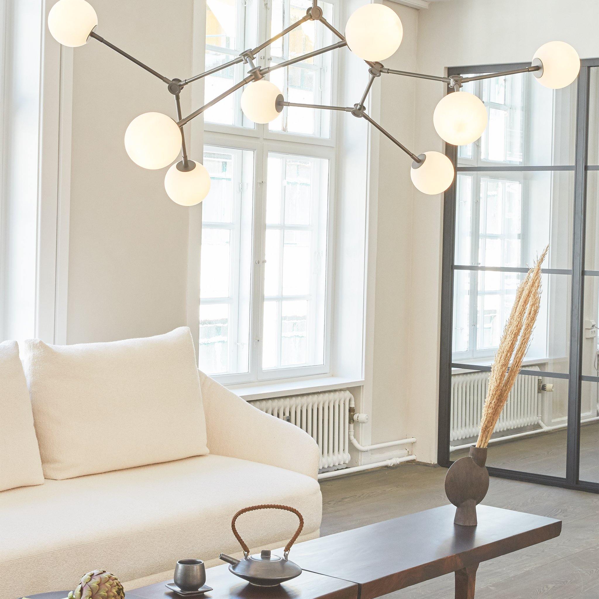 101 CPH DROP BULB Chandelier in a white living room over a table- Luminesy